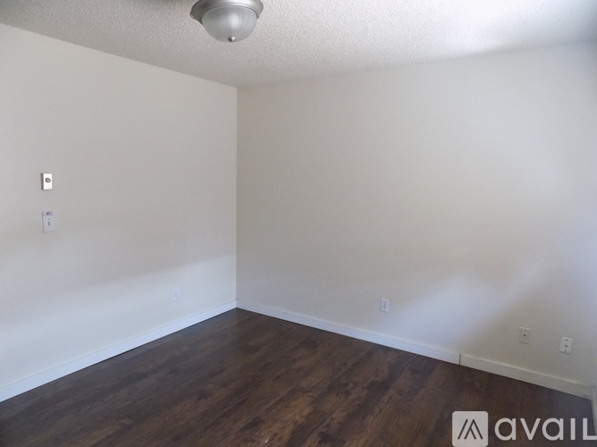A room with wooden floors and white walls.