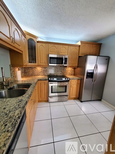 A kitchen with granite countertops and stainless steel appliances.