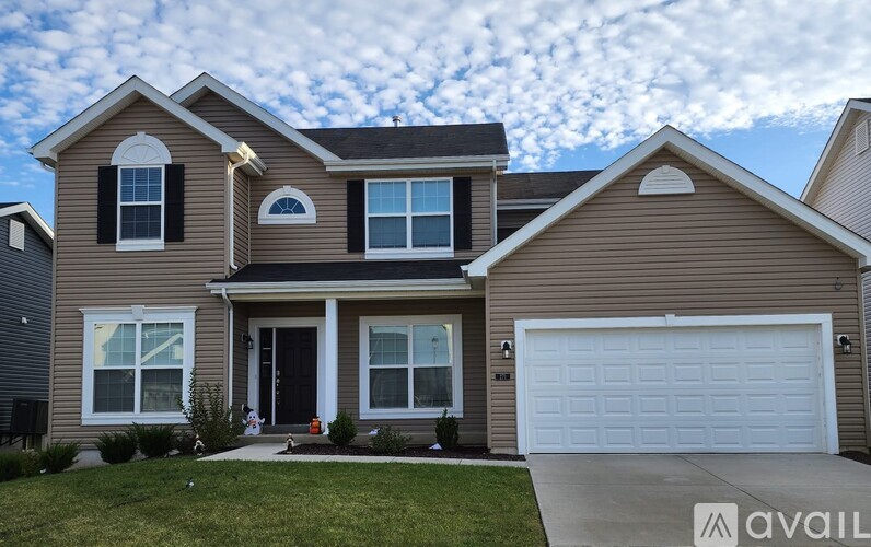 A house with a garage is for sale.