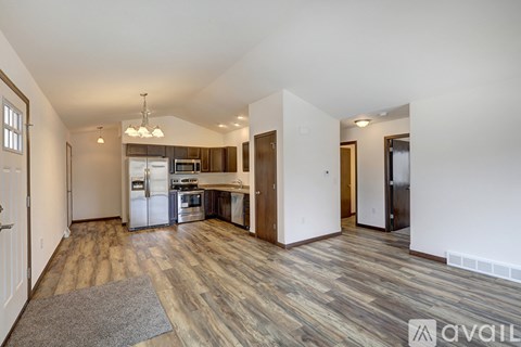 A kitchen with a refrigerator, oven, and microwave.