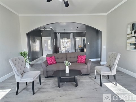 A living room with a grey couch and a coffee table.