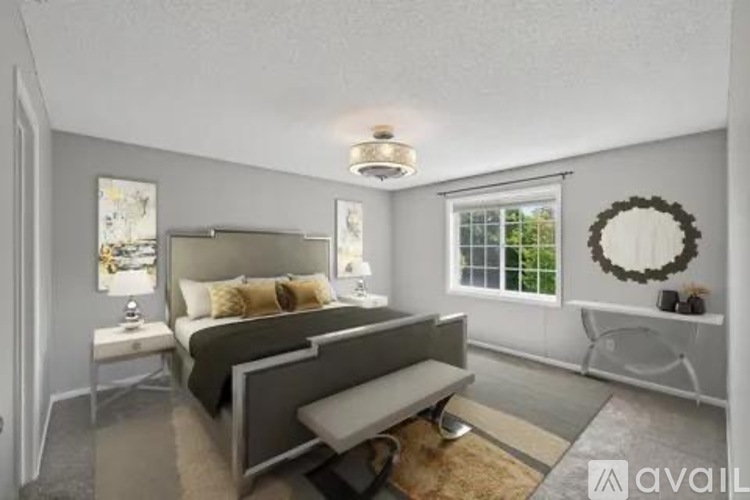 A bedroom with a large bed and a bench seat.