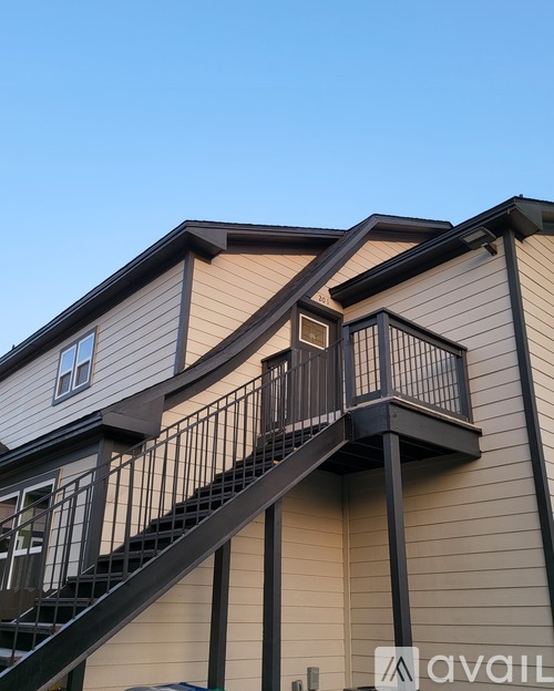 A modern house with a staircase leading to the upper floor.
