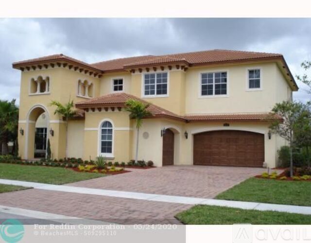 A two-story house with a garage is for sale.