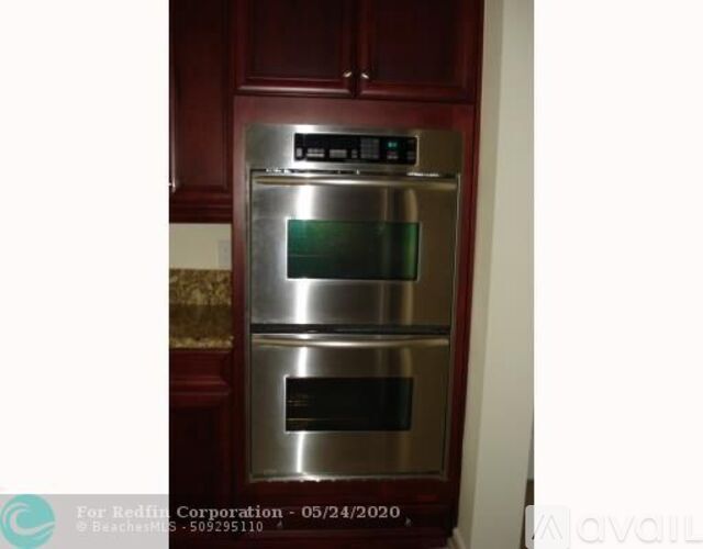 A stainless steel double oven built into a kitchen cabinet.