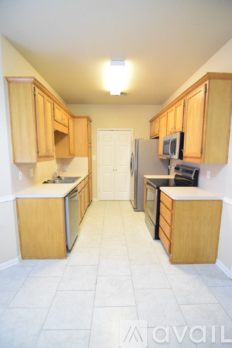 A kitchen with wooden cabinets and a white refrigerator.