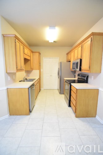 A kitchen with wooden cabinets and a white refrigerator.