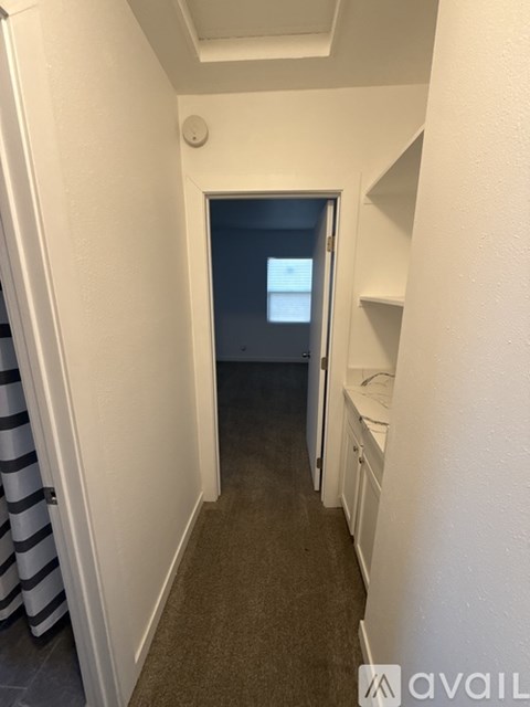 A hallway with a door at the end.