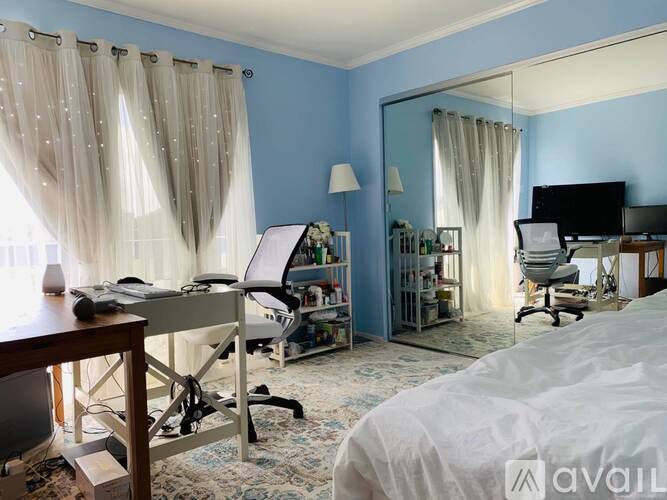 A room with a sliding glass door leading to a balcony.