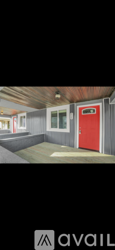 A red door is on the right side of a grey wall.