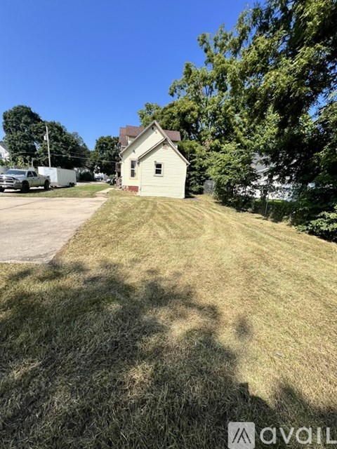 A small house with a white truck parked in front of it.