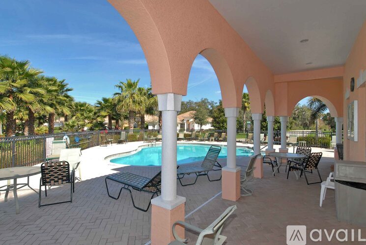 A pool area with a table and chairs.