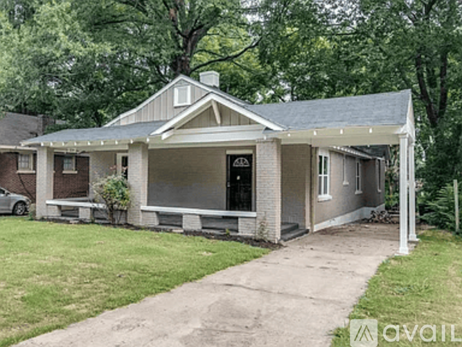 A house with a grey roof and a black door is for sale.
