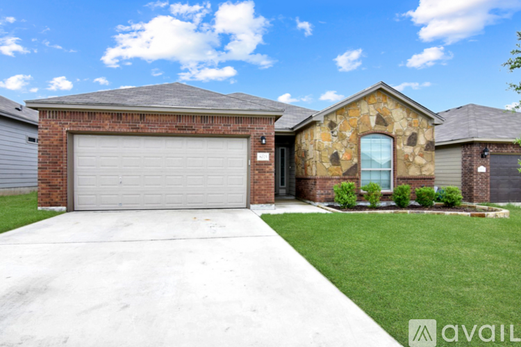 A house with a garage door and a driveway.