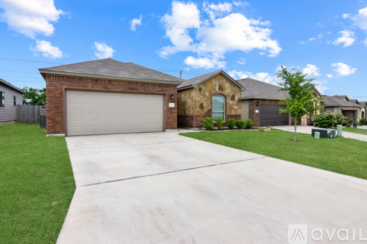 A house with a garage and driveway in front.