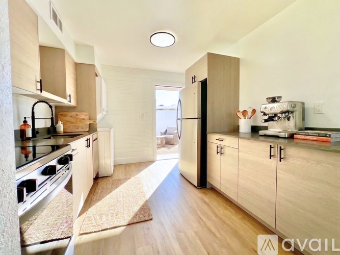 A kitchen with wooden cabinets and a stove top oven.