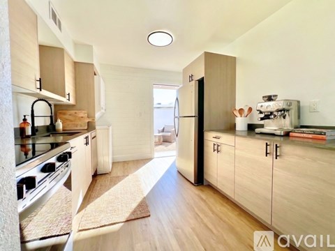 A kitchen with wooden cabinets and a stove top oven.