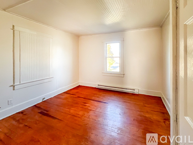 A room with wooden floors and white walls.