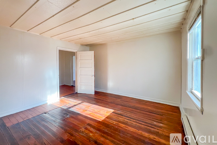 A room with wooden floors and white walls.