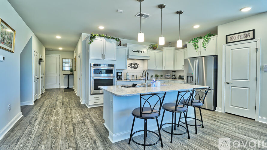 A kitchen with a bar area and chairs.