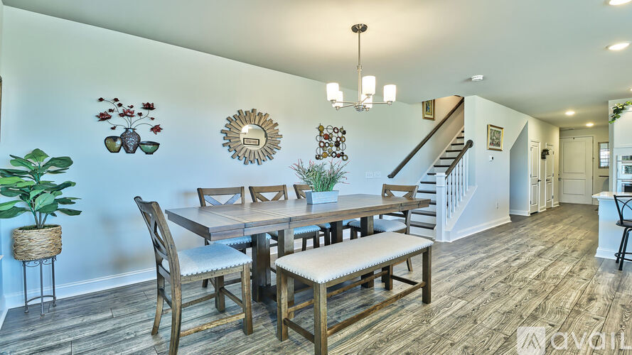 A dining room with a wooden table and chairs.