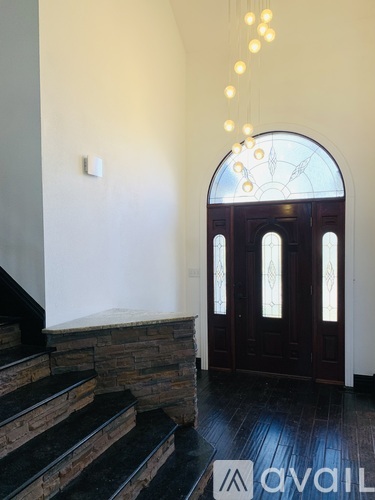 A staircase with a stone base leads to a doorway with a glass window.