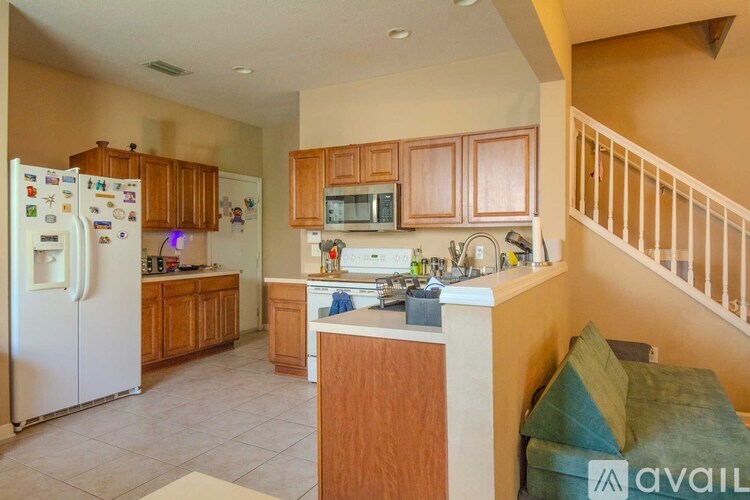 A kitchen with wooden cabinets and a white refrigerator.
