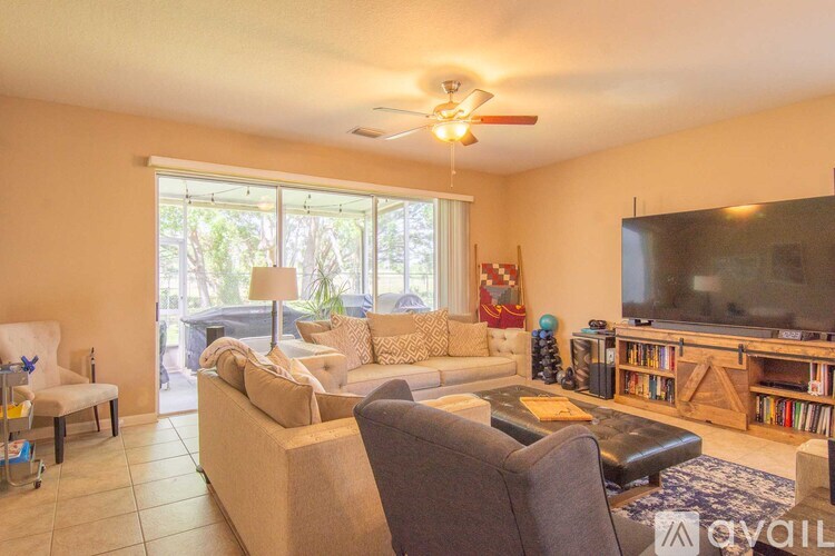 A living room with a grey couch and a television.