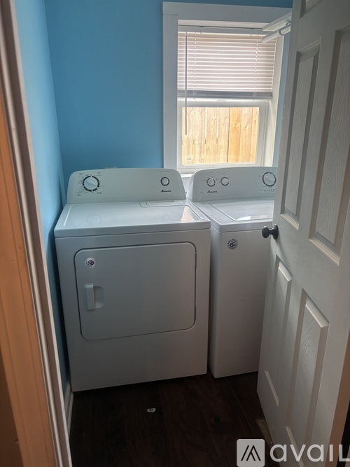 A small white washing machine and dryer in a small room.
