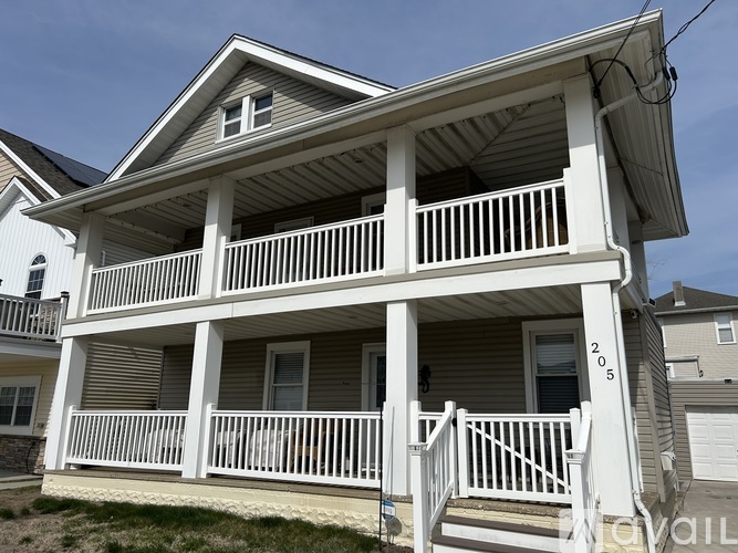 A two-story house with a balcony is for sale.
