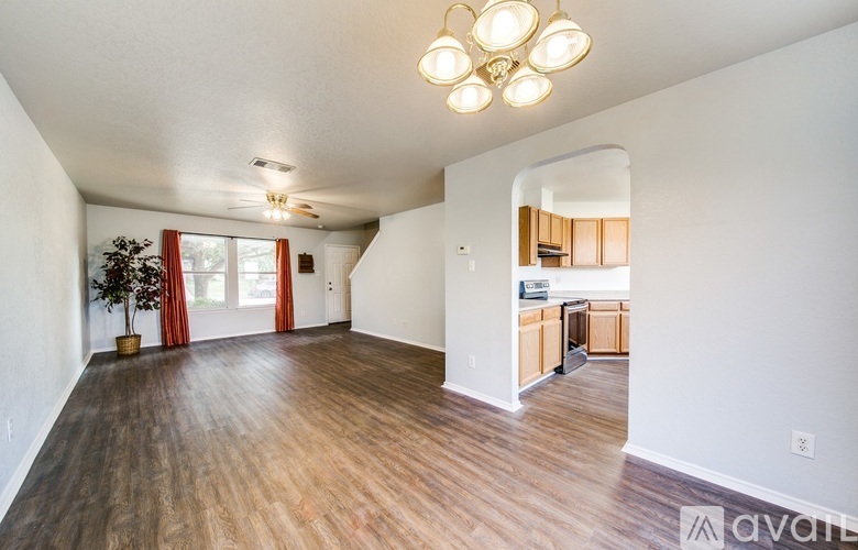 A living room with a wooden floor and a ceiling light.