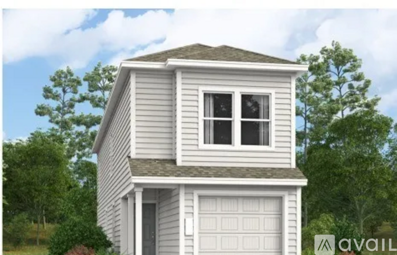 A two-story house with a garage is available for purchase.