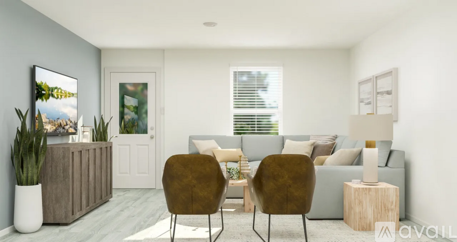 A modern living room with a grey sofa, two chairs, and a wooden cabinet.