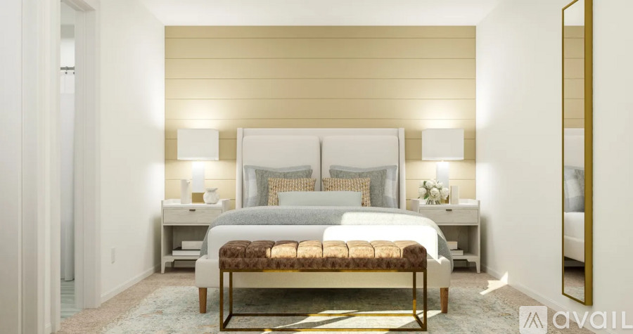 A bedroom with a large bed and a bench in front of it.