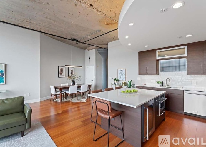 A modern kitchen with a dining table and chairs.