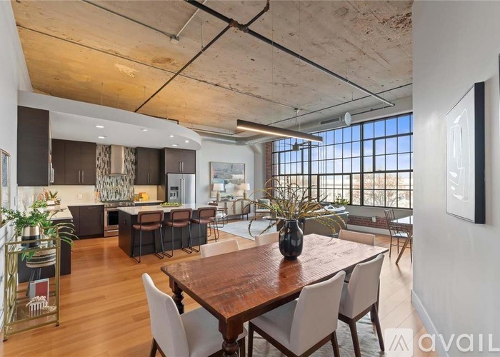 A modern dining room with a wooden table and chairs.
