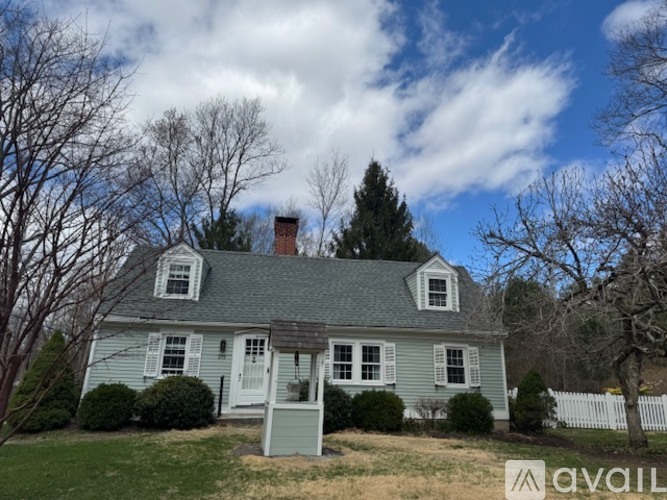 A house with a white picket fence in front.