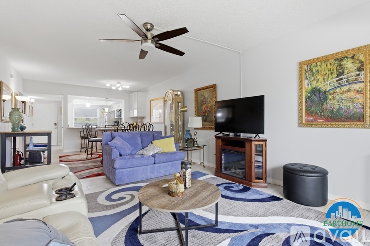 A living room with a blue couch and a television.