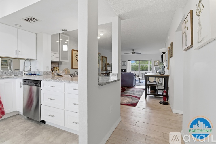 A kitchen with white cabinets and a dishwasher.