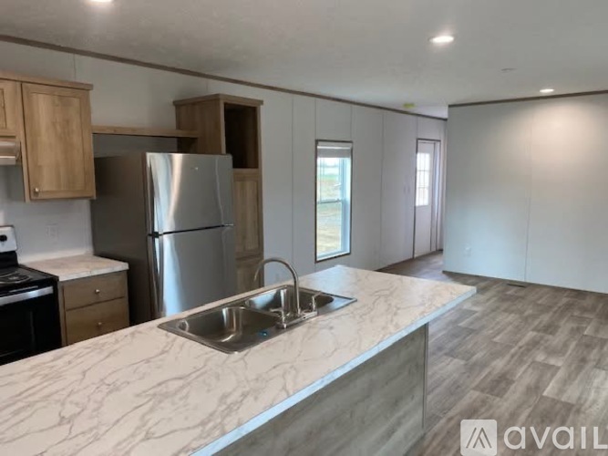 A kitchen with a marble countertop and stainless steel appliances.
