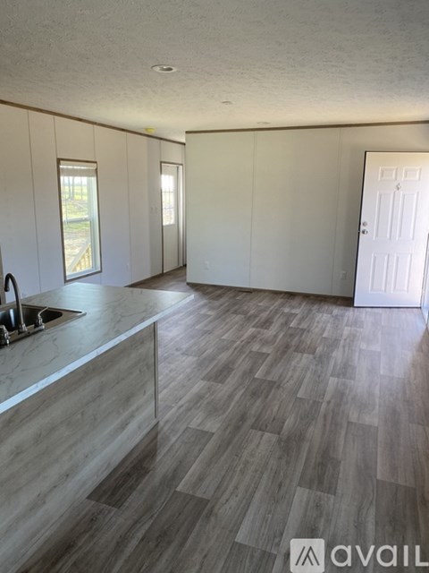 A kitchen with a sink and a counter top.