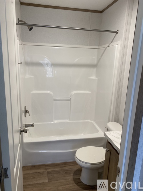 A white bathroom with a toilet and a bathtub.