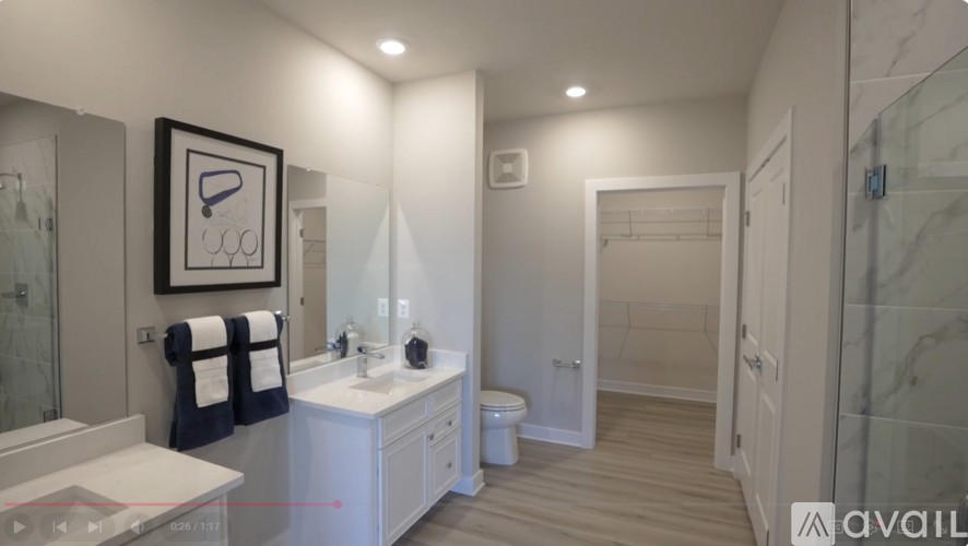 A bathroom with a sink, mirror, and towel.