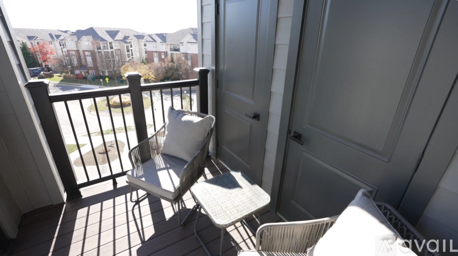 A balcony with a chair and table is shown.