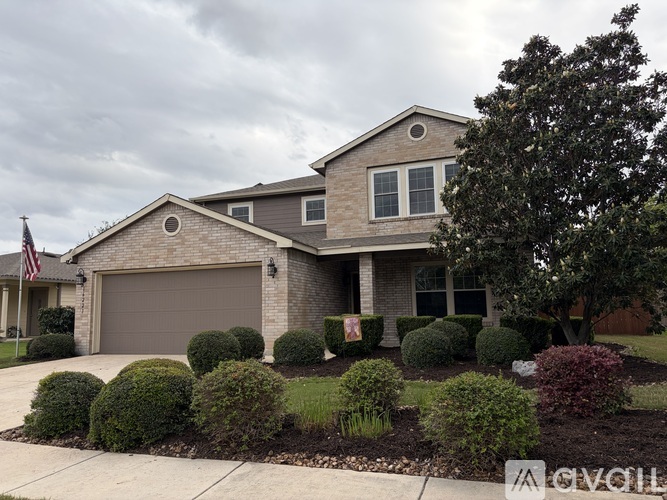 A house with a grey garage door and a flag on the left.