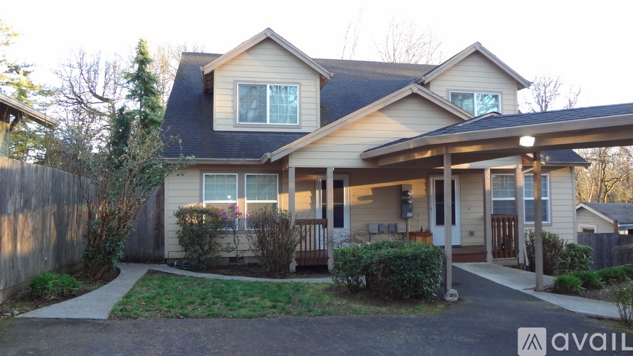 A house with a front yard and a driveway leading to the front door.