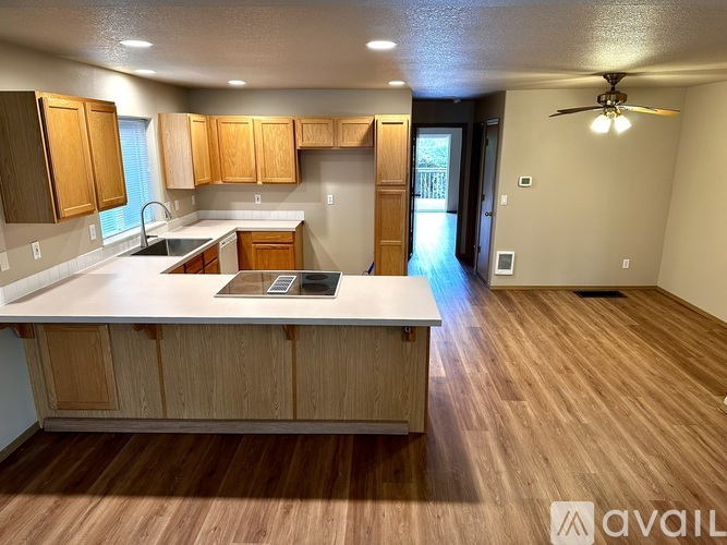 A kitchen with wooden cabinets and a countertop.
