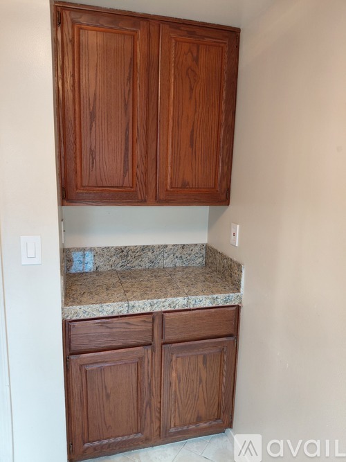 Brown cabinets above a counter top.