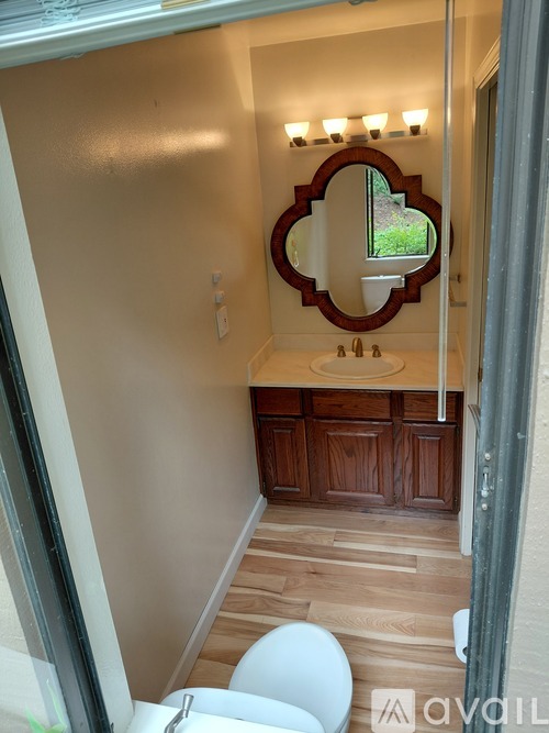 A small white closet with a door and shelves.