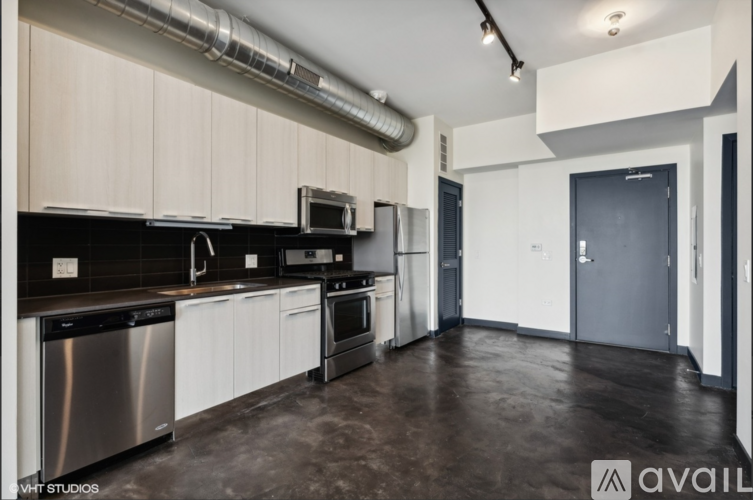 A kitchen with stainless steel appliances and white cabinets.